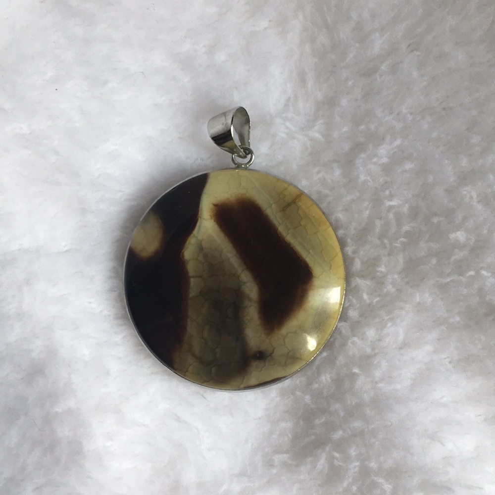 Round double-sided pendant in earth tones